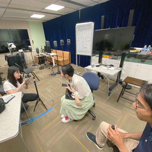 Ms Peksi screwing the sound meter to a stand.