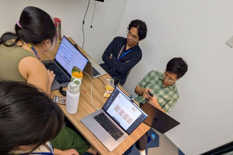4 people looking at their computers.