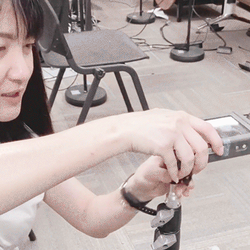 Ms Peksi screwing the sound meter to a stand.