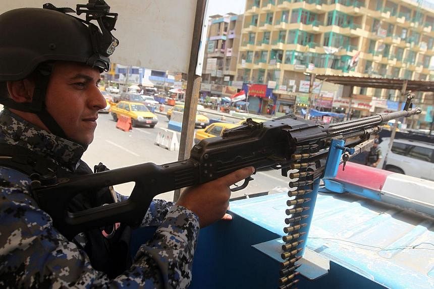 An Iraqi policeman mans a checkpoint in the capital Baghdad on June 12, 2014. -- PHOTO: AFP