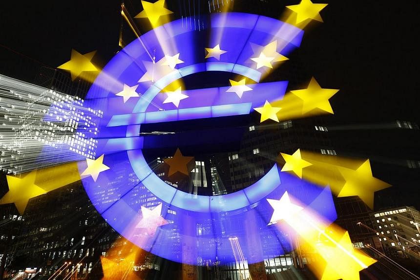 The famous euro sign landmark is photographed outside the former head quarters of the European Central Bank in Frankfurt, late evening Jan 20, 2015. -- PHOTO: REUTERS