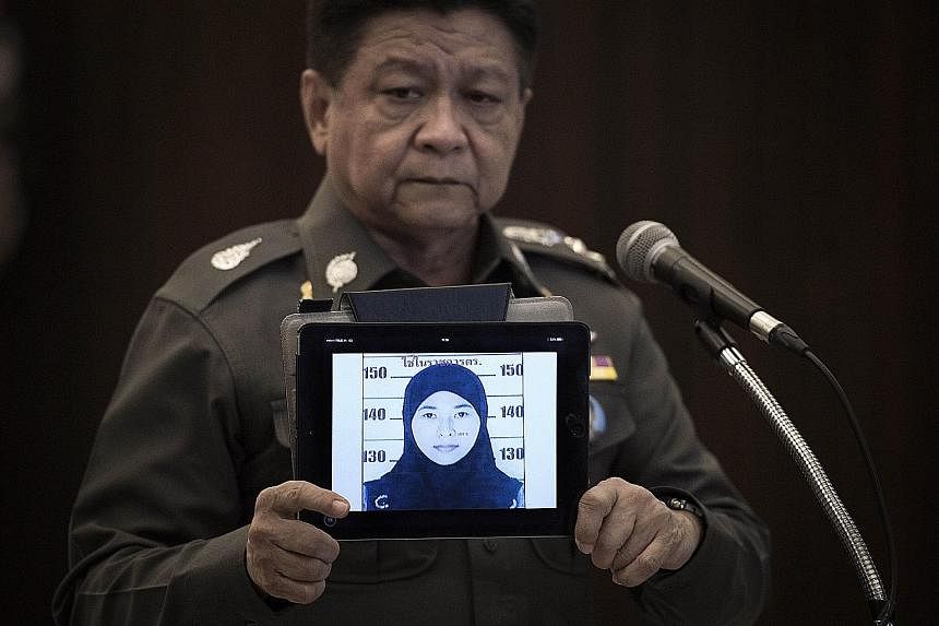 Thailand's national police spokesman Prawut Thavornsiri (left) displaying a picture of suspect Wanna Suansant yesterday, after bomb-related materials were found in a flat she had rented. (Above) A police arrest warrant handout of a sketch of an unide