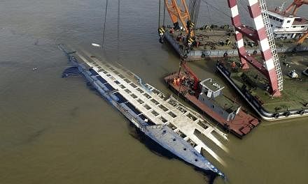 An aerial view of rescuers working on righting the capsized cruise ship Eastern Star, in Jianli, Hubei province, China, June 5, 2015. -- PHOTO: REUTERS