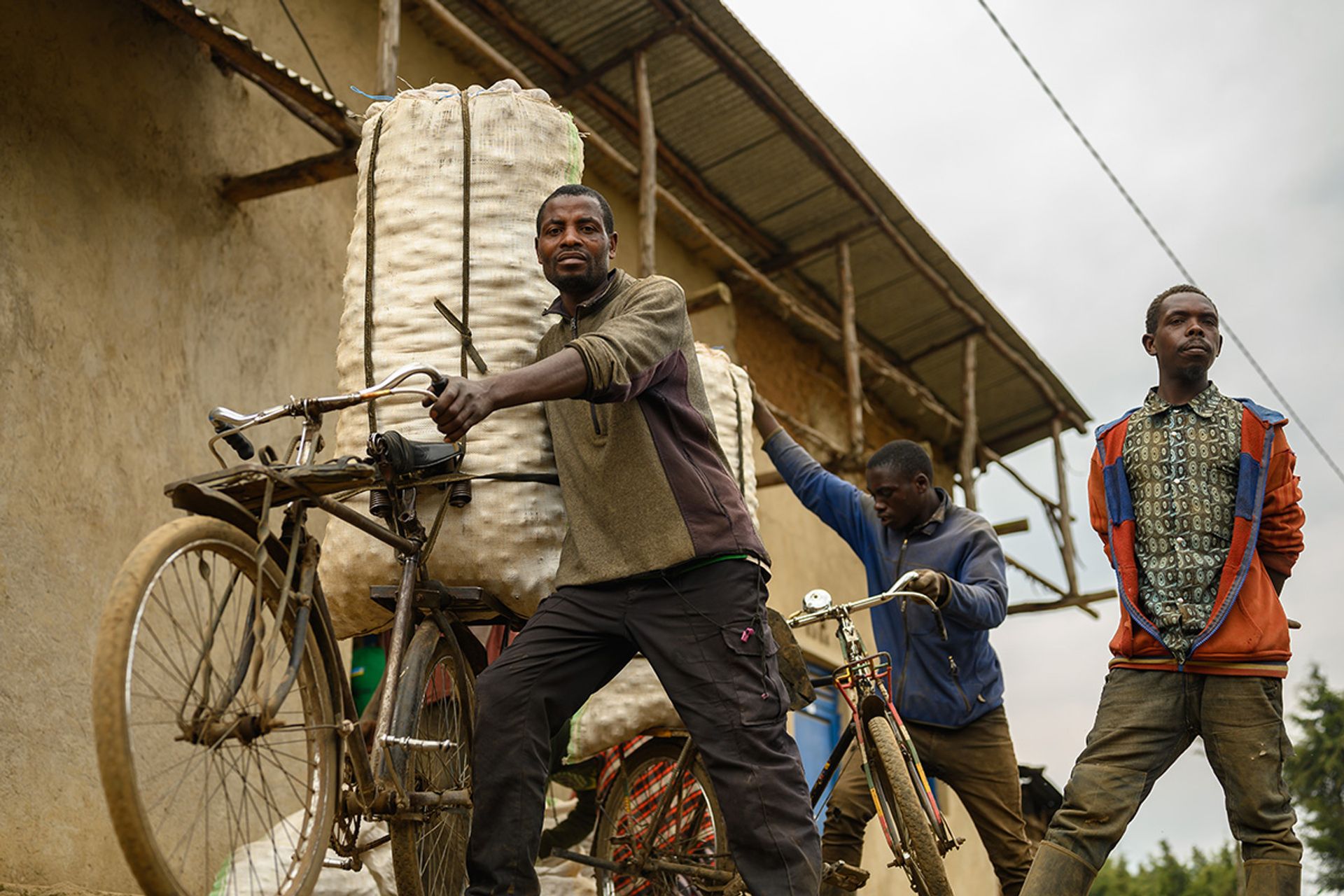 Potato farmer Innocent Munyawera, 38, pushing a bike laden with potatoes weighing up to 200kg.